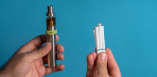 Men holding electronic cigarette on colored background background